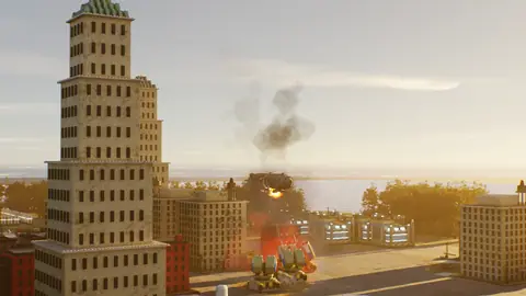 Brick towers with smoke and a fireball rising behind them.