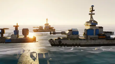 Brick destroyers at sunset with the sun glittering on the water.